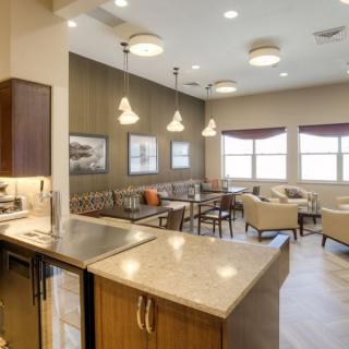 A modern interior kitchen and dining area with stylish lighting and comfortable seating.