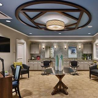 A modern salon interior with stylish lighting and comfortable seating.