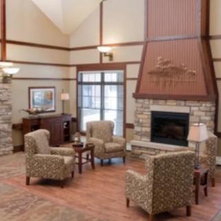 A cozy lounge area with comfortable seating and a warm fireplace.