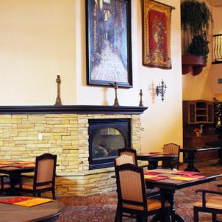 A cozy dining area with elegant seating and a warm fireplace.