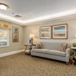 A cozy living room with comfortable seating, artwork, and soft lighting.