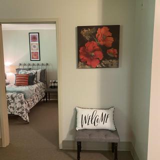 A cozy hallway leading to a bedroom with floral decor and welcoming accents.