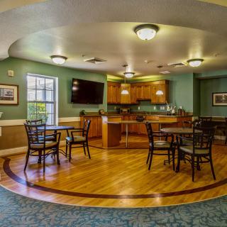 A cozy kitchen and dining area with wooden floors and comfortable seating.