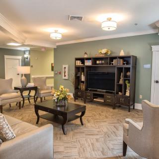 A cozy living room with elegant furniture and a large entertainment center.