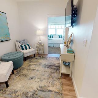 A cozy modern living room with stylish decor, featuring comfortable seating and soft lighting.