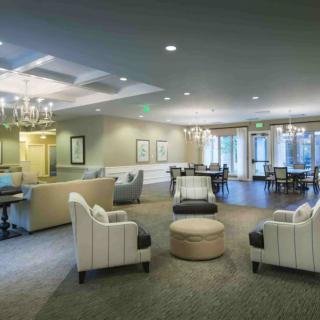 A modern lobby with comfortable seating and elegant chandeliers.