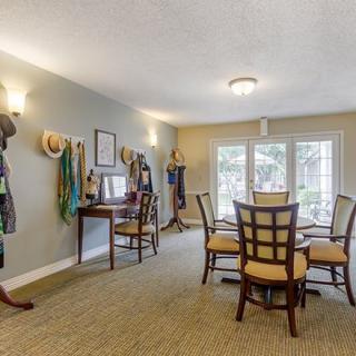 A well-lit dining room featuring a table and chairs, with stylish decor and natural light coming through the windows.