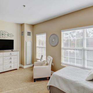 A modern, minimalist bedroom filled with natural light.
