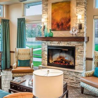 A cozy living room with a stone fireplace and elegant decor.