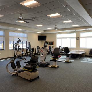 A spacious fitness center with various exercise equipment.