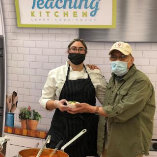 A culinary demonstration in a teaching kitchen, showcasing the art of food preparation.