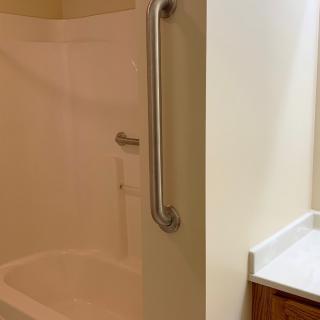 An accessible shower with a grab bar for safety.