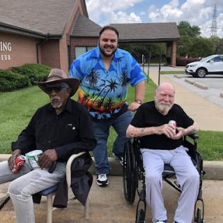 A joyful moment shared among friends outside a community center.