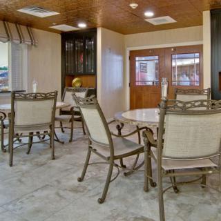 A cozy dining area with tables and chairs arranged neatly.
