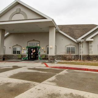A building with a prominent entrance and an overhanging awning on an overcast day.