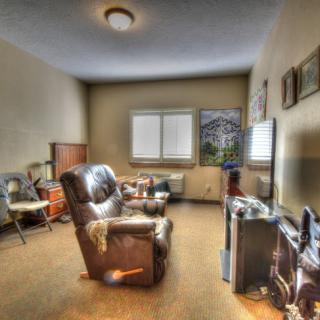 A cozy living room with retro furnishings and a TV.