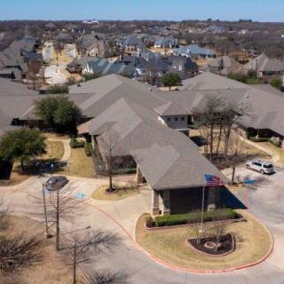 Aerial view of a suburban neighborhood with multiple buildings and roads.