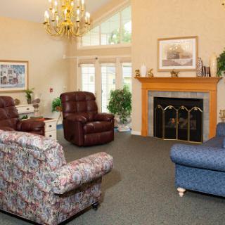 A cozy living room featuring comfortable recliners and a classic fireplace.