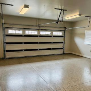 A spacious and clean garage interior with an automated door.