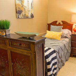 A cozy and stylish bedroom featuring elegant furniture, decorative accents, and a warm atmosphere.