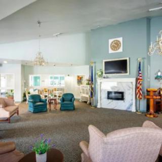 A spacious living area with comfortable seating, fireplace, and television, creating a cozy atmosphere.