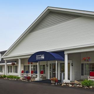 A small inn with a welcoming entrance and a blue awning.