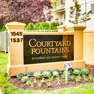 Sign for Courtyard Fountains at the entrance of a residential building.