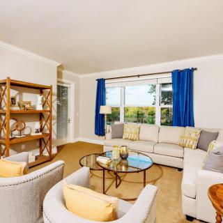 A bright and cozy living room with modern furniture and a large window.