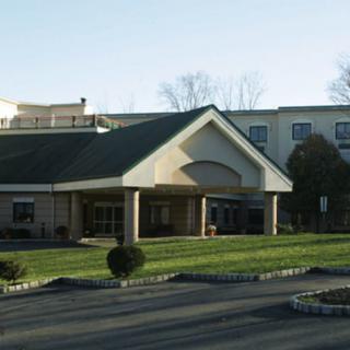 A hotel building with a landscaped entrance area.