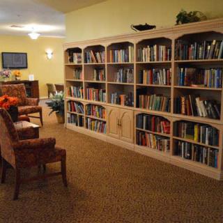 A cozy library with bookshelves and seating area.