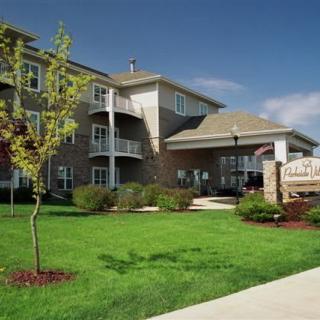 Exterior view of a residential apartment building with well-maintained landscaping.
