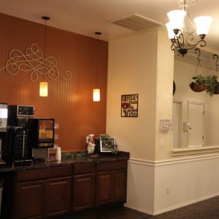 A cozy coffee station with warm lighting and decorative elements.