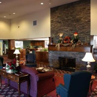 A cozy hotel lobby with a fireplace and comfortable seating area.