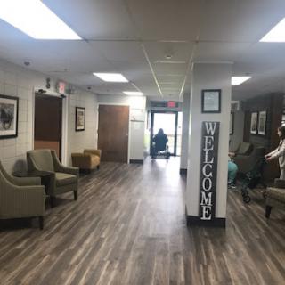 A welcoming waiting area featuring comfortable seating and decorative photographs.