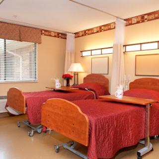 A well-designed hospital room featuring two patient beds, designed for comfort and functionality.