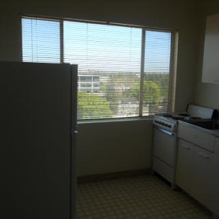 A bright kitchen featuring a window with a view of the outdoors.
