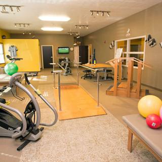 A well-equipped gym with various exercise and physical therapy equipment.
