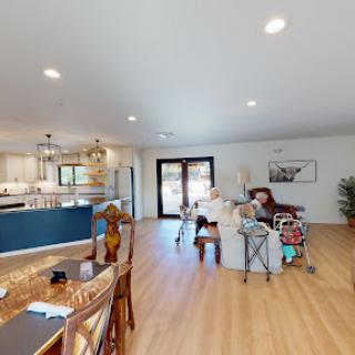 A spacious and inviting living room with an open layout, featuring modern decor and natural light.