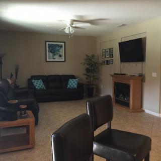 A cozy living room with sofas, a television, and decorative elements.