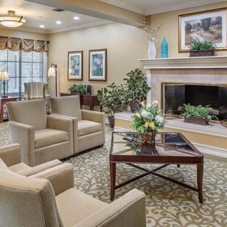 A cozy living room with comfortable seating, a fireplace, and elegant decor.