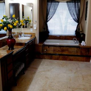 A beautifully designed bathroom featuring elegant fixtures, a cozy bathtub, and natural light filtering through the window.