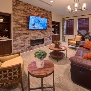 A cozy living room with stylish decor and a brick accent wall.
