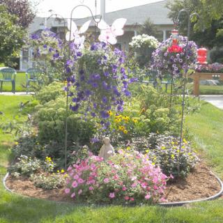 A vibrant garden filled with blooming flowers and decorative butterfly motifs.