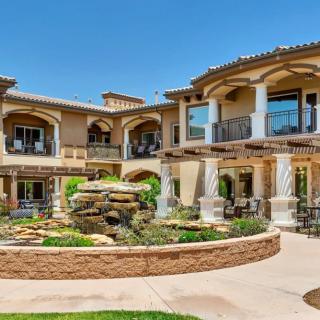 A luxurious mansion with a beautiful garden and fountain, featuring intricate architectural details and spacious balconies.