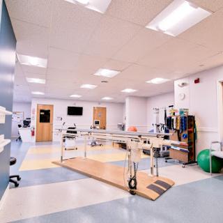 A spacious rehabilitation center equipped with therapy tools and equipment.