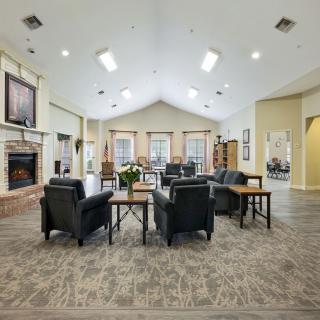 A spacious and well-lit lobby with comfortable seating and a fireplace.