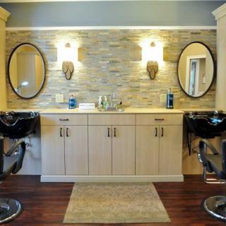 A stylish bathroom vanity with dual mirrors and sconces.