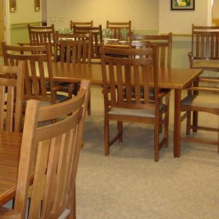 A dining area with wooden tables and chairs arranged neatly.