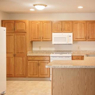 A modern kitchen with wooden cabinets and a central island.