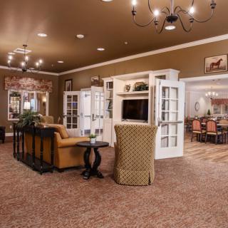 A cozy living room with elegant furnishings and lighting.